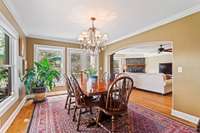 Large entry way into the living room creates an open and inviting feel, while still giving you separate spaces. Large windows create natural light.