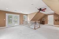 Double doors lead out to a deck that leads to the backyard. Door on the right leads to a very large storage area.