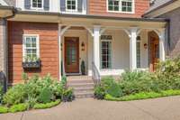 Welcoming front porch with 2 entrances-1 to the entry foyer and 1 to the drop zone