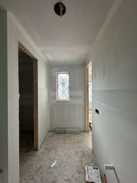 Bedroom #4 connected decorative glass doors to a covered deck. *this home is under construction. Photo taken 9/14/24