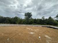 Large private and serene backyard backs up to mature trees.   *this home is under construction. Photo taken: 9/14/24