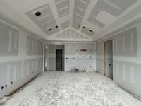 Bonus Room with vaulted ceiling, wet bar, and natural light on the second level. *this home is under construction. Photo taken: 9/14/24