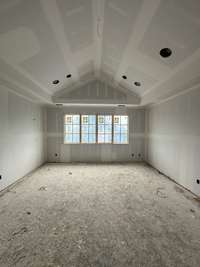 Bonus Room with vaulted ceiling, wet bar, and natural light on the second level. *this home is under construction. Photo taken: 9/14/24