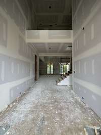 Grand two-story foyer off the front porch and terrace. *this home is under construction. Photo taken: 9/14/24