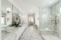 Breathtaking primary bathroom boasting Quartz, marble, and gold.  Oversized show and glorious soaking tub with French doors to extra large walk-in closet with island and large 2nd "his" closet