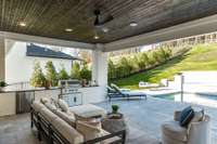 Huge outdoor living space perfect for entertaining or private relaxation space!. Built in kitchen grill and mini fridge.