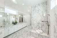 Breathtaking primary bathroom boasting Quartz, marble, and gold.  Oversized shower with rainhead and handhelds.  Top tier plumbing fixtures