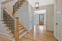 Central Staircase Leads Up to Secondary Bedrooms and Bonus, Cafe Doors Leads Down to Incredible Flex Space