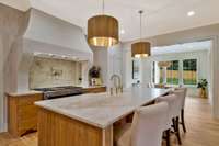 Custom Arc Stone Hood frames the Natural Taj Mahal Quartzite Counters in Both the Kitchen and Scullery