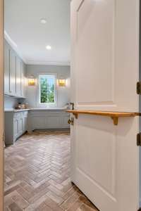 The Laundry Room of Your Dreams, Dutch Door and Herringbone Brick Add to the Beauty