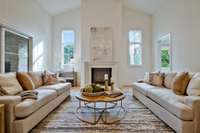 Custom Arc Stone Fireplace Mantle Anchors this Serene Family Room with 14 Foot Ceilings