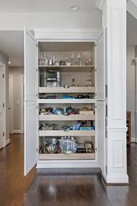 New pull out pantry system also houses electronics to keep the house tidy.