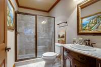 A beautifully finished full bathroom in basement with walk-in shower, perfect for guests or everyday use