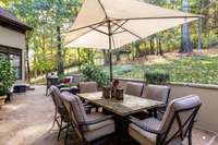 Private patio includes multiple seating areas for outdoor dining or entertaining guests