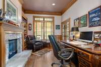 Work in style and comfort in a comfortable office with rich warm trim and a stunning 2-sided fireplace