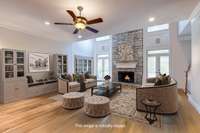 Spacious family room featuring a soaring 25-foot stacked stone fireplace—an impressive focal point perfect for cozy gatherings.