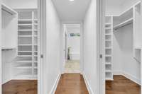 Primary bedroom suite features 2 custom walk-in closets on each side of the walkway to the Primary bath