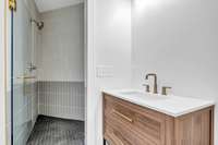 Private bath with walk in tile shower for the downstairs bedroom suite.