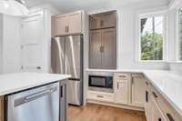 Nice pantry to left of refrigerator & below counter microwave.