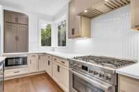 Gas stove & corner windows in kitchen