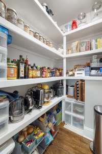 This pantry is a dream - built in shelving and space for food and kitchen gadgets!