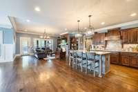 This open concept living space is absolute perfection - plenty of room to spend time with friends and family while working in the kitchen.