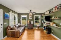 The living room just inside the front door with gleaming hardwood floors