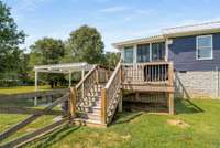 Large deck off the sunroom leading to the fenced portion of the back yard.