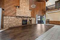 massive open living space, with fireplace to gather friends and family around.