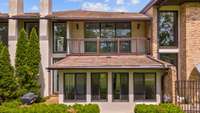 View of the rear of the home featuring a patio with built in gas grill and Florida Room