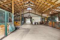 Inside the barn, a spacious and well-organized walkway provides easy access to the stalls and tack rooms. This well-designed space ensures the comfort and safety of your animals, and every detail is designed with the horse enthusiast in mind.