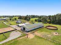 From this vantage point, appreciate the full scale of the barn and its surrounding pastures. A true testament to the property’s commitment to quality and care. Designed with intention, this space is ready to accommodate your equestrian needs.