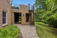 Beautiful spiral staircase connects patio and deck.