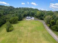 Perched majestically atop a scenic hill, the newly constructed home offers breathtaking panoramic views of the entire 40-acre estate.