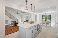 A large kitchen island serves as a central focal point, offering ample counter space for meal preparation, casual dining, or socializing.