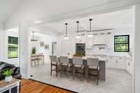 The bright white kitchen is a stunning centerpiece of the home, featuring a clean and contemporary design that exudes elegance.