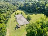 The outdoor riding arena is another highlight of the property, featuring a spacious, level surface ideal for training and riding.