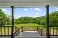 Whether you're sipping your morning coffee, reading a book, or simply enjoying the fresh air, this porch serves as the perfect spot to unwind and appreciate the tranquil landscape.