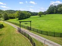 At the main entrance, a beautifully designed gate welcomes you. This gate combines aesthetic appeal with functionality, offering a charming yet formidable barrier.