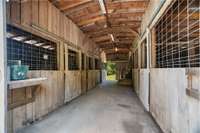 Wide aisles and large doors ensure easy access for horses and equipment, making the barn user-friendly and safe.