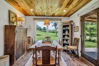 OPEN CONCEPT Dining Area w/ Incredible Hardwood Floors Wood Plank Ceiling balanced with Neutral Paint