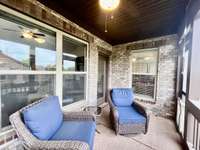 Screened backporch overlooking lots of green space; Wood ceiling with ceiling fan.