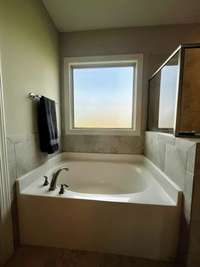 Enjoy relaxing in this Garden tub in the Primary Bath Suite.