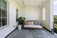 Slate-tiled front porch with a cozy swing to enjoy the views