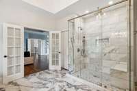 Primary bath features marble and natural stone finishes