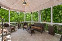 The lounge overlooks the wooded back yard which leads to the water.