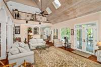 French doors in the living room open directly onto one of the outdoor living spaces.