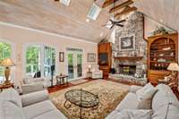 The wood-burning fireplace is made of the same stone as the exterior of the home. Notice the custom-built cabinetry on both sides.