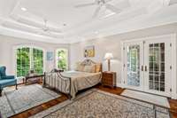 The cherry flooring extends throughout the entire main level of the home. The bedroom has its own private doorway to the upper deck.