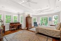 Just past the kitchen and walk-in pantry, the primary bedroom suite continues the "tree-house" experience.